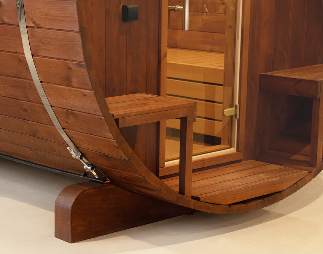 Showcasing the inside of a wooden barrel sauna.