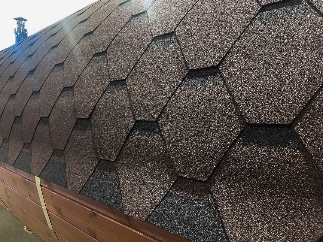 Showcasing the inside of a wooden barrel sauna.